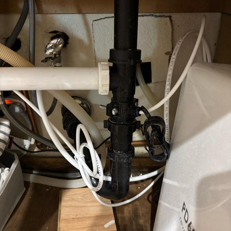 Kitchen drain pipe with RO drain saddle installed