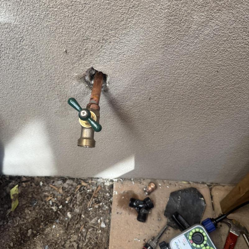 Hose bib valve and copper pipe with repair tools outdoors Hose bib valve and copper pipe with repair tools outdoors