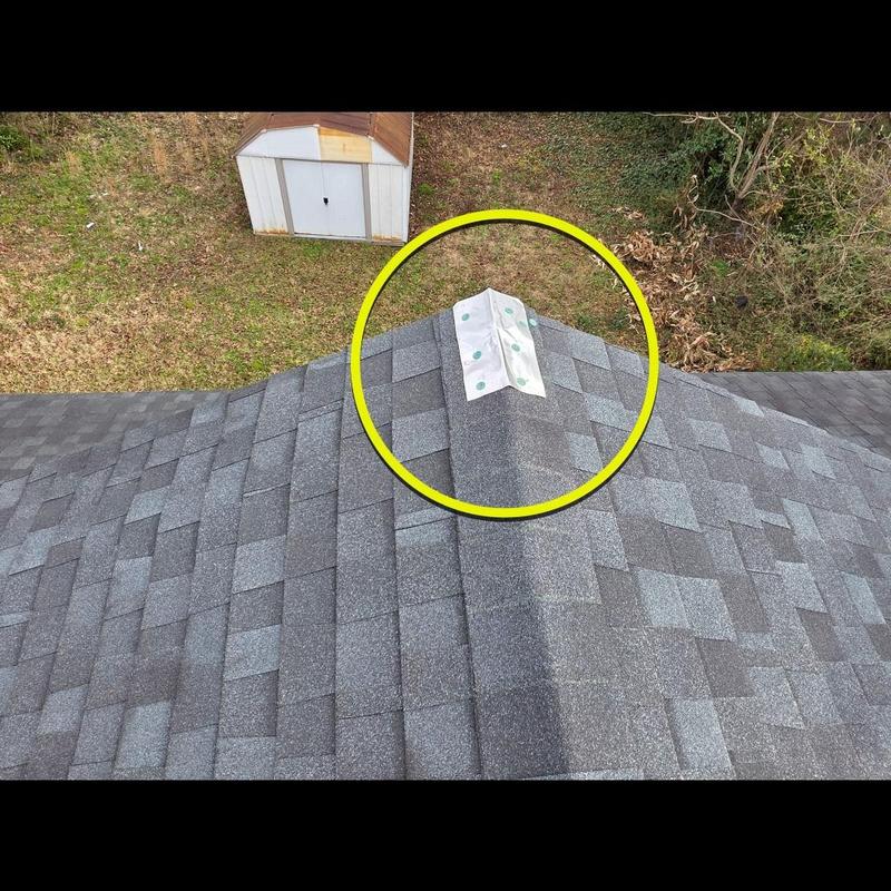 Ridge cap shingles with roofing sealant on residential roof Ridge cap shingles with roofing sealant on residential roof