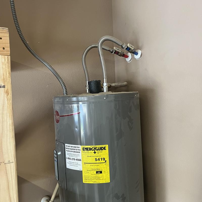 50 gallon tank water heater with supply lines in corner