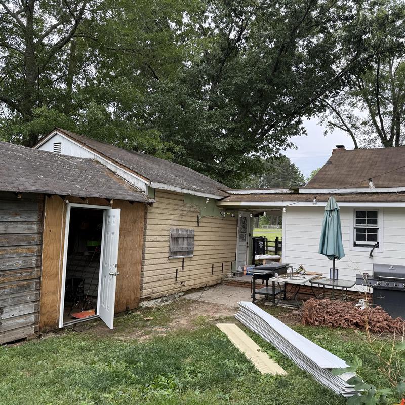 Roof deck and siding on historic farmhouse exterior