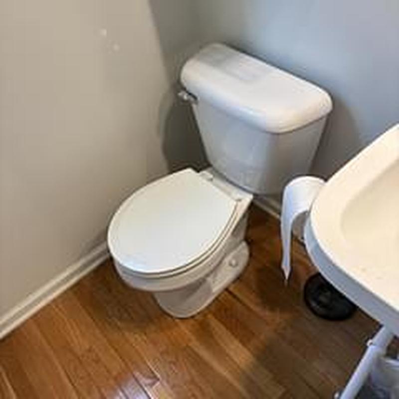 Mansfield round toilet bowl with hardwood floor