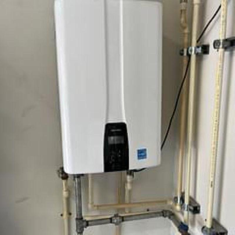 Tankless water heater with piping and control panel Tankless water heater with piping and control panel