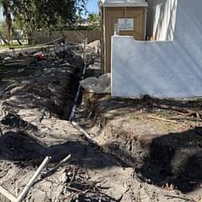 Sewer line trench excavation near building foundation Sewer line trench excavation near building foundation