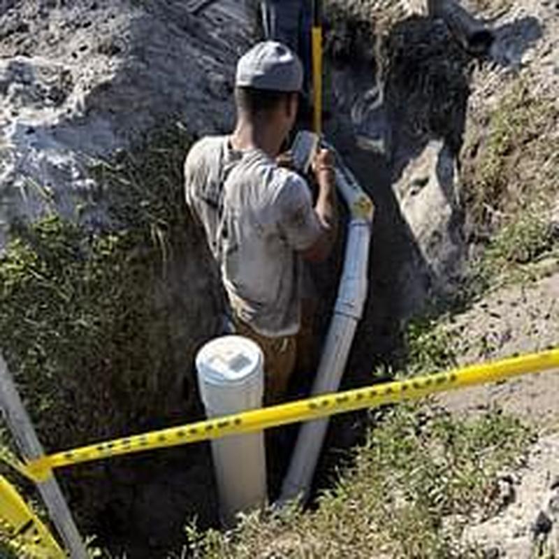 Sewer line installation with level checking in trench Sewer line installation with level checking in trench