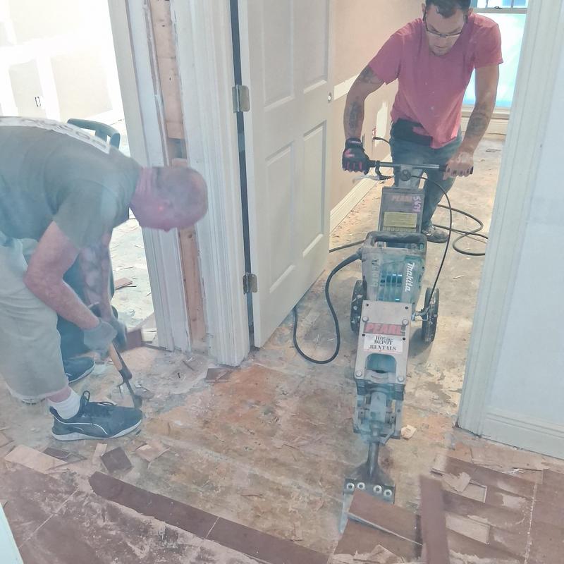Wood floor demolition with jackhammer and crowbar