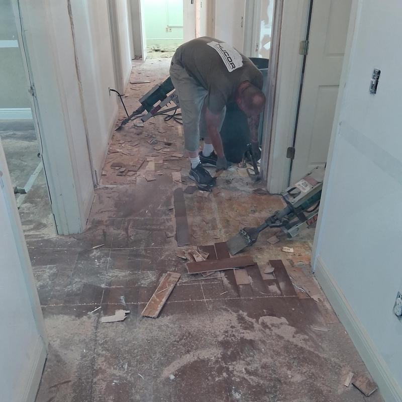 Wood flooring demolition in commercial hallway remodel