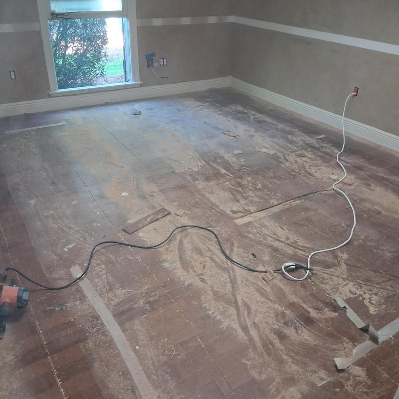 Wood subfloor demolition with dust and tools