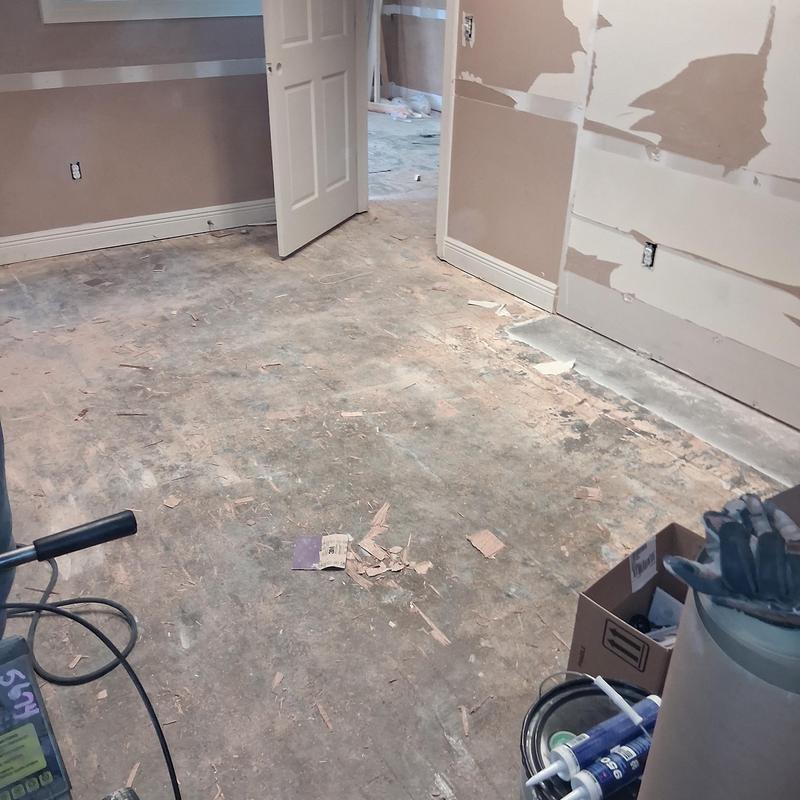 Concrete floor demo with drywall repair in progress