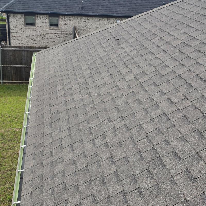 Asphalt shingle roof with visible hail damage areas