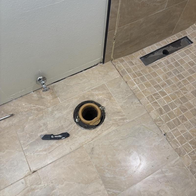 Toilet flange and shower drain plumbing in bathroom floor Toilet flange and shower drain plumbing in bathroom floor