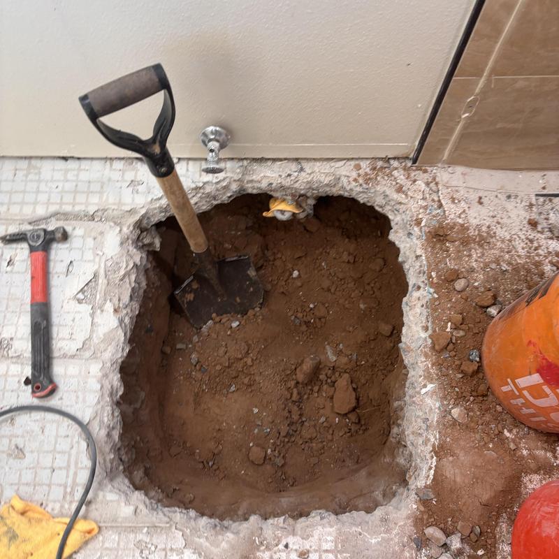 Floor plumbing excavation with shovel and tools Floor plumbing excavation with shovel and tools