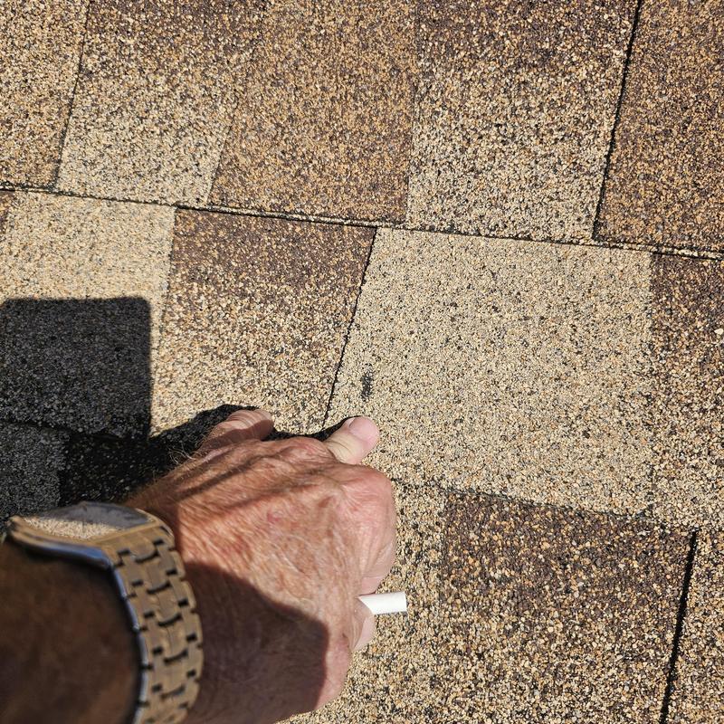 Asphalt shingle roof showing hail damage close-up