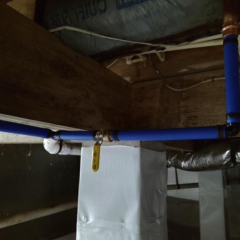 Canister water filter with blue PEX piping installation Canister water filter with blue PEX piping installation