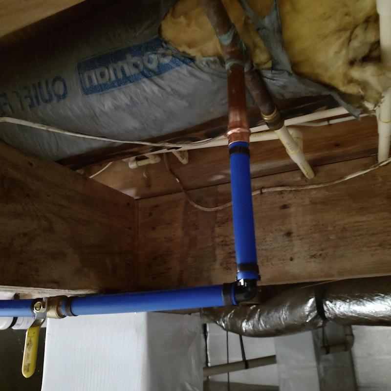 Blue PEX water supply pipes with fittings in ceiling space Blue PEX water supply pipes with fittings in ceiling space