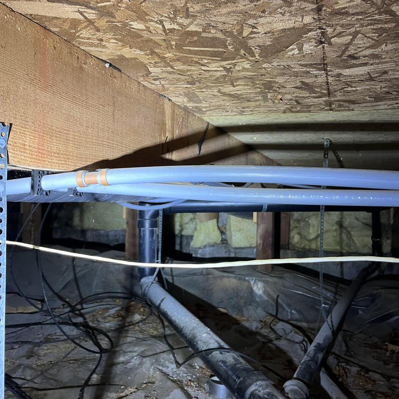 PEX water piping installed in crawl space ceiling joists