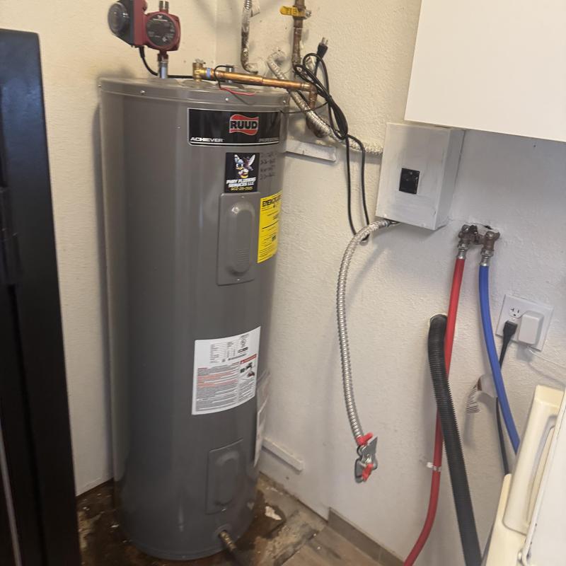 Water heater installed in laundry room corner Water heater installed in laundry room corner