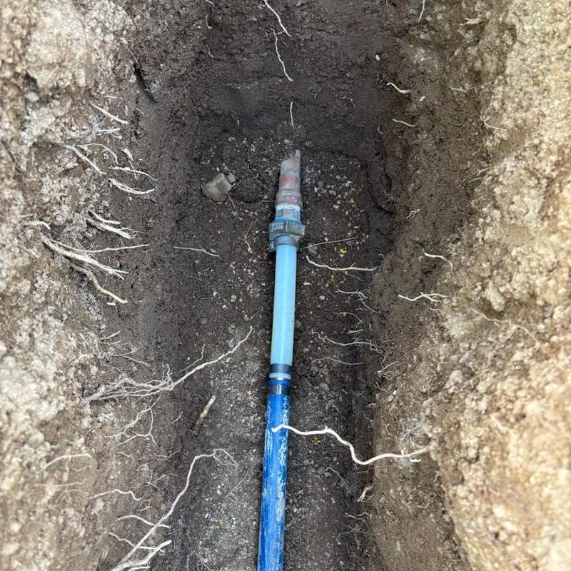 PEX water main line with repair couplings in trench
