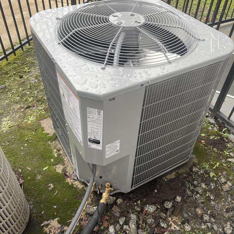 HVAC outdoor condenser unit with rain droplets