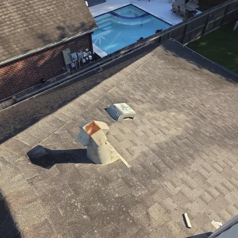 Asphalt shingle roof with rusted vent pipe and damage Asphalt shingle roof with rusted vent pipe and damage