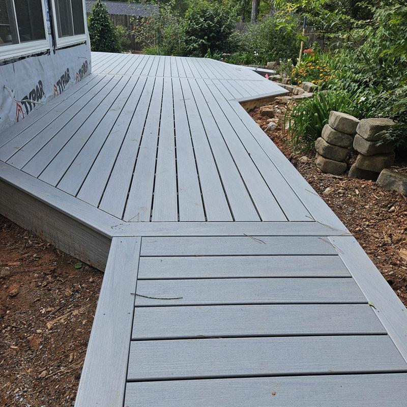 Composite deck addition with angled design near garden