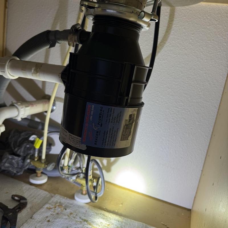 Garbage disposal unit installed under kitchen sink