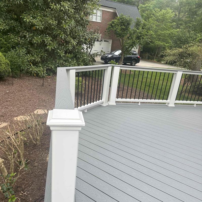 Composite deck with white and black railing balusters