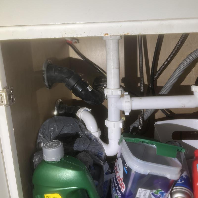 Kitchen sink drain pipes and plumbing under cabinet