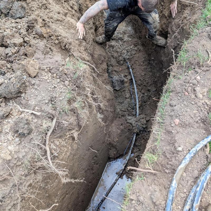 Water service line trench with tracer wire installation