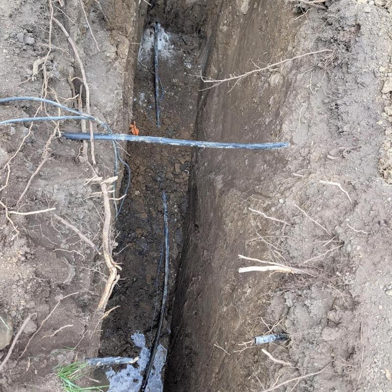 Water service line trench with tracer wire installation