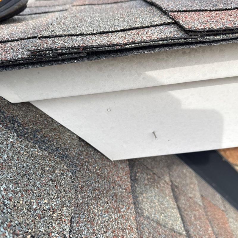 Asphalt shingle roof with nail and soffit panel detail