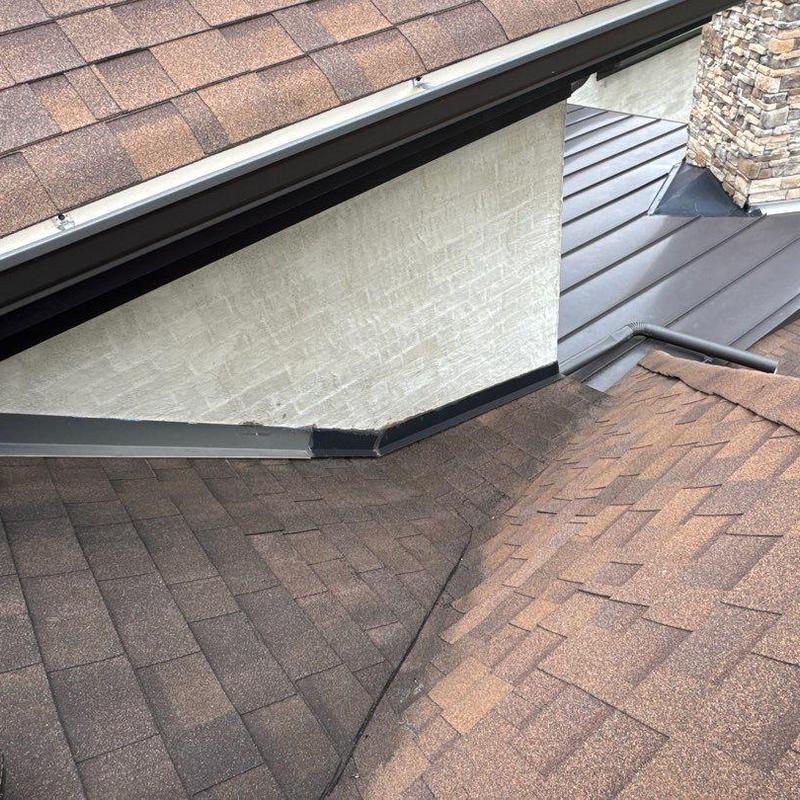 Shingle roofing with metal flashing at corner detail