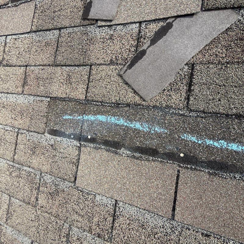 Asphalt shingles with hail damage and lifted granules