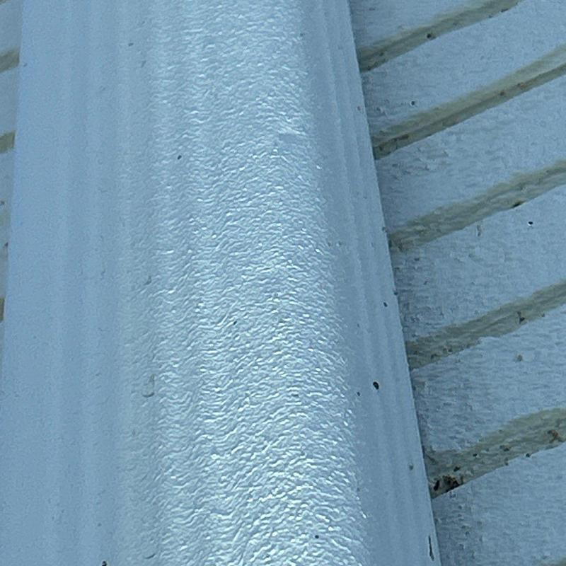Metal flashing with minor hail damage close-up