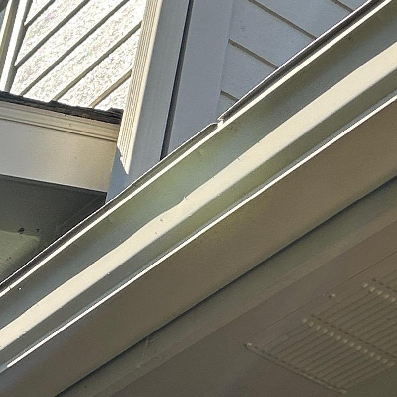 Aluminum gutter with corner joint and siding trim