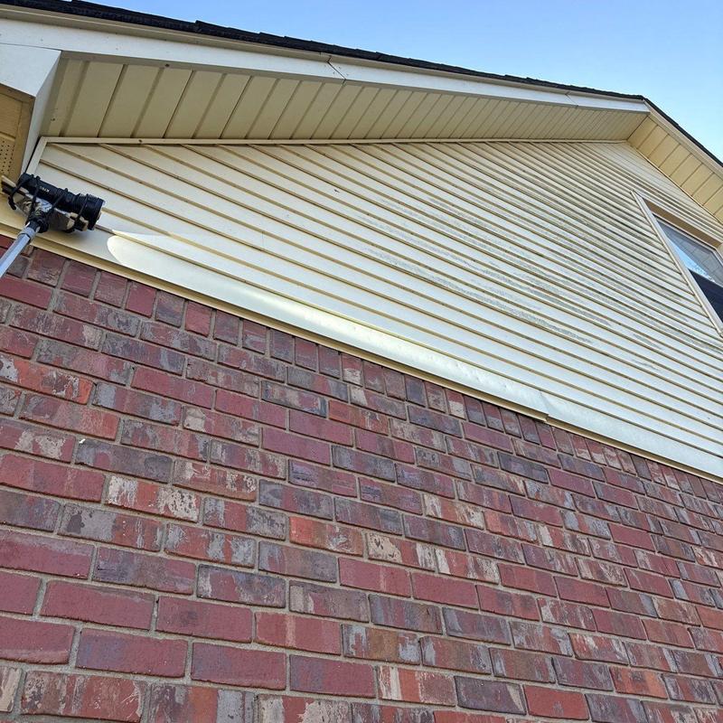 Vinyl siding discoloration and brick wall exterior view