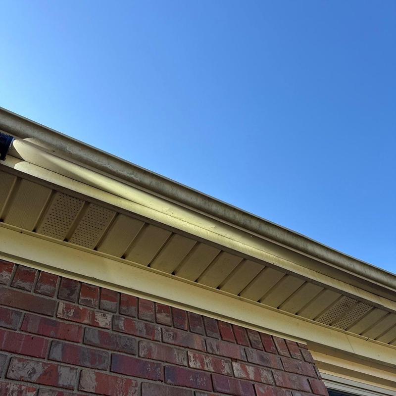 Roof gutter and soffit under eave with clear sky