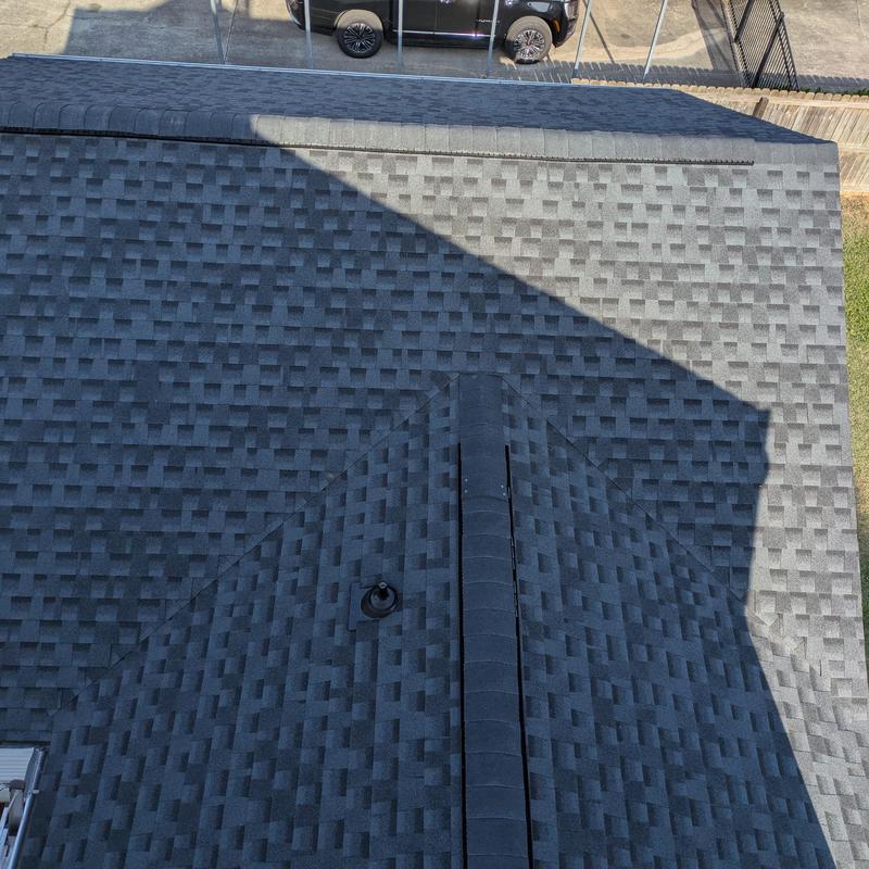 Asphalt shingle rear roof with ridge vent and vent pipe