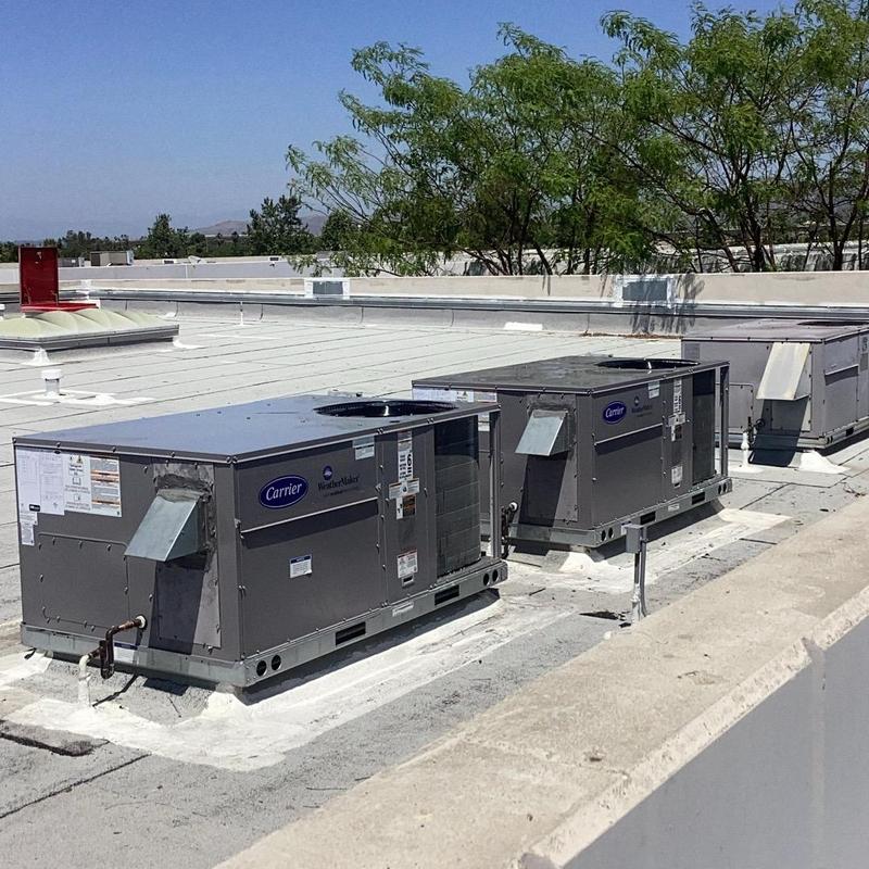 Carrier rooftop package HVAC units on commercial building roof Carrier rooftop package HVAC units on commercial building roof