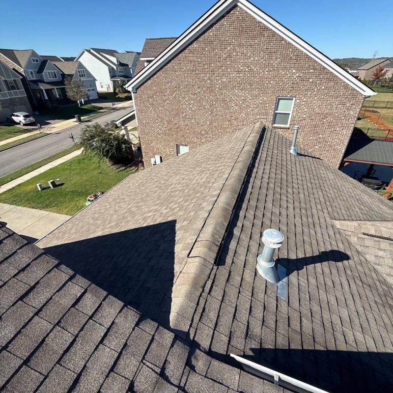 Asphalt shingle roof with ventilation pipe and ridge cap