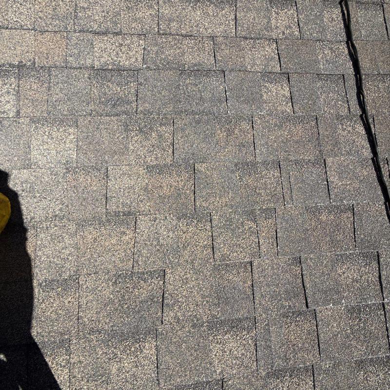 Asphalt shingle roof with hail damage and wear