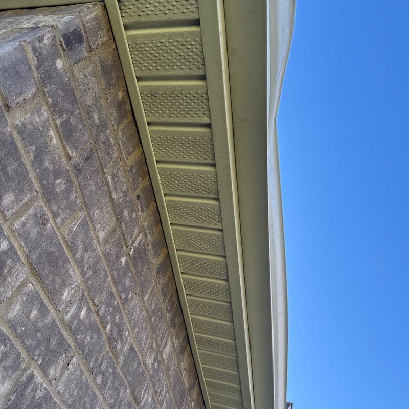 Roof soffit and gutter system inspection under clear sky