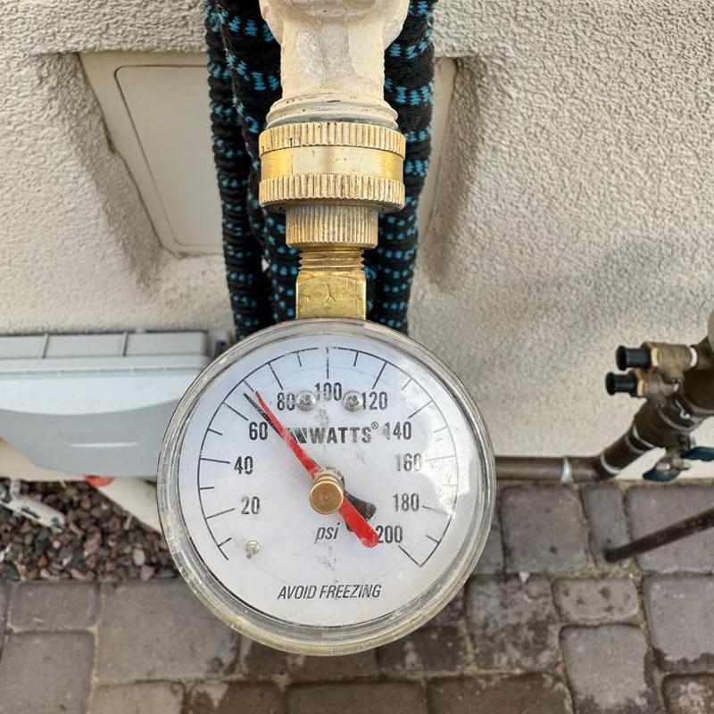 Water pressure gauge on irrigation main at 68 PSI