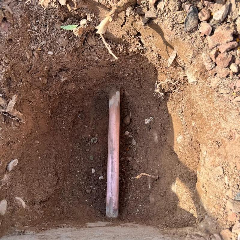 Water main exposed in dug out soil trench Queen Creek AZ