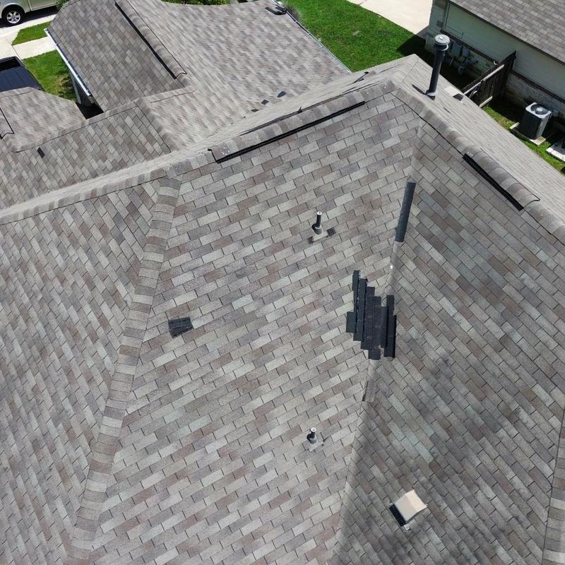 Asphalt shingle roof with wind storm damage patching