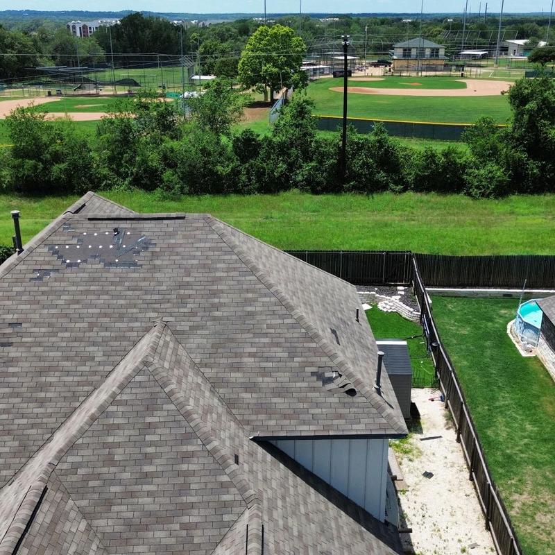 Shingle roof with wind storm damage and missing tiles