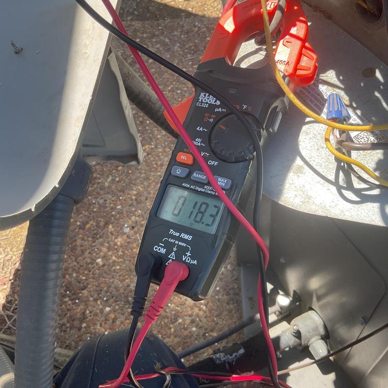 Digital clamp meter measuring HVAC electrical current