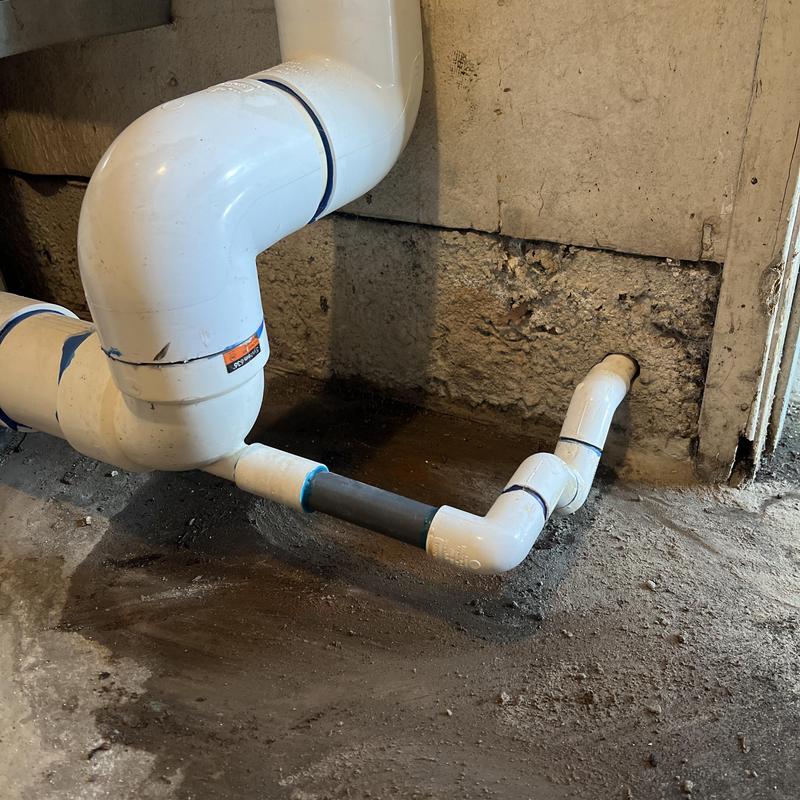 Condensate venting pipe installation near concrete wall Condensate venting pipe installation near concrete wall