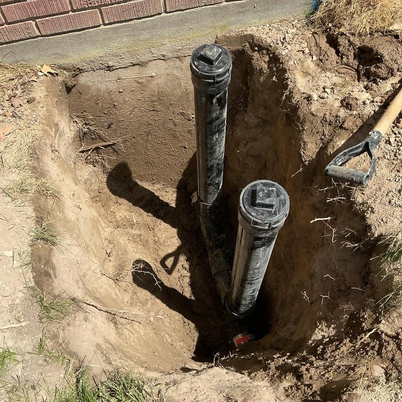 Outside sewer cleanout pipes installed in dirt trench Outside sewer cleanout pipes installed in dirt trench