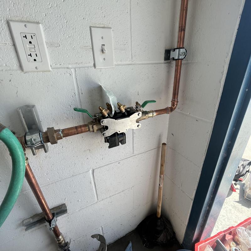 Backflow assembly with copper piping and valves on wall Backflow assembly with copper piping and valves on wall